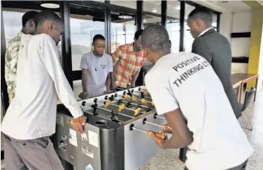  ?? Photos by Marissa Lang / Special to The Chronicle ?? Entreprene­urs play foosball on the roof deck of kLab, a co-working space and tech incubator in Kigali, Rwanda, in November. The country’s desire to become a tech hub conflicts with government control.