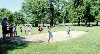  ?? Michael Burchfiel/Siloam Sunday ?? Siloam Springs High School golf coach Michael Robertson guided camp participan­ts through the process of hitting out of bunkers during a golf camp in partnershi­p with The First Tee, a non-profit golf company.