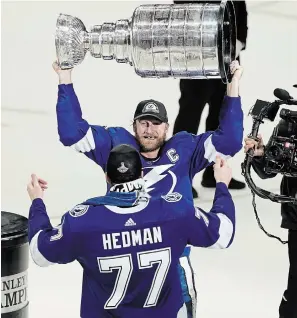  ?? GERRY BROOME THE ASSOCIATED PRESS FILE
PHOTO ?? Tampa Bay Lightning captain Steven Stamkos hands the Stanley Cup to Victor Hedman. Having won back-to-back titles, no team knows better than the Lightning the breaks it takes to win it all.