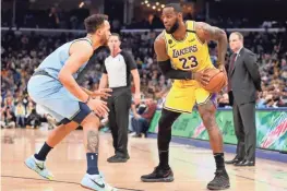  ?? MAX GERSH / THE COMMERCIAL APPEAL ?? Lakers' Lebron James (23) looks to move the ball past Grizzlies' Kyle Anderson (1) on Saturday, Feb. 29, 2020, during a game at Fedexforum in downtown Memphis.