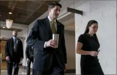  ??  ?? House Speaker Paul Ryan of Wis. (center), accompanie­d by his Press Secretary AshLee Strong (right) walks to the Capitol Building from the Capitol Visitor’s Center on Thursday in Washington. AP PHOTO/ ANDREW HARNIK