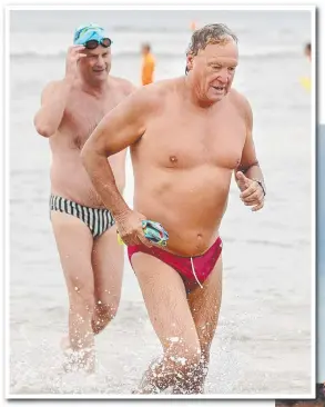  ?? Picture: ALISON WYND ?? Cats CEO Brian Cook hits the beach yesterday.