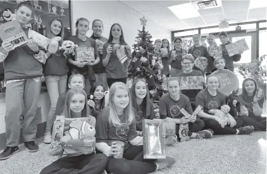  ?? [ALI WILSON / THE OBSERVER] ?? Park Manor Senior Public School student council students show off their Week of Giving items in the school’s front foyer. Front row: Kayla R, Hailey. Middle row: Allie, Amy, Emily, Sara, Alexis, Natalie. Kneeling beside tree: Ian, Eric. Back row:...