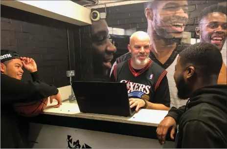  ?? Photo by Candace Buckner / The Washington Post ?? Jason Henley, center, operates a gym at Black Prince Trust in London. While NBA games sell out O2 Arena, the sports struggles in England.