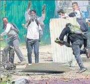  ?? AP FILE ?? Students throw stones at security personnel during a protest in Srinagar on Monday.