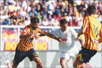  ??  ?? Lecce’s Luca Rossettini (left) and Juventus’ Paulo Dybala vie for the Italian Serie A soccer match between Lecce and Juventus at Mare stadium in Lecce, Italy, on Oct. 26. MArcO lezzI/ANSA VIA AP