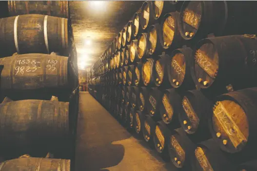  ?? BILL ZACHARKIW FILES ?? The ancient Romans accidental­ly discovered that wine stored in lead vessels was less prone to spoilage. Above: Wine more sensibly aging in oak barrels.