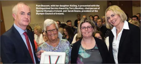  ??  ?? Pam Beacom, with her daughter Aisling, is presented with the Distinguis­hed Service Award by Terry Buckley, chairperso­n of Special Olympics Ireland, and Sarah Keane, president of the Olympic Council of Ireland,