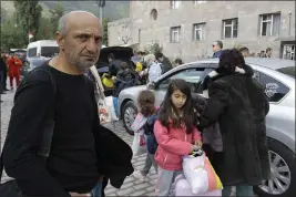  ?? VASILY KRESTYANIN­OV — THE ASSOCIATED PRESS ?? Ethnic Armenians arrive in Goris, Armenia, on Monday after exiting the Nagorno-Karabakh region of Azerbaijan. Armenian forces lost control of the breakaway region last week.