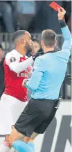  ??  ?? Alexandre Lacazette receives a red card.