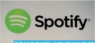  ??  ?? NEW YORK: This file photo taken on December 11, 2013 shows a Spotify logo seen as founder and CEO Daniel Ek addresses a press conference. —AFP