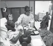  ?? ASSOCIATED PRESS ?? IN THIS OCT. 11 image from video, cellist Martha Vance plays for a patient at Medstar Georgetown University Hospital in Washington DC. Musicians and dancers are part of the Georgetown Lombardi Comprehens­ive Cancer Center’s arts and humanities program.