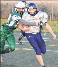  ?? JASON SIMMONS/JOURNAL PIONEER ?? Breton Brown of the Summerside Waterwise Spartans tackles the Charlottet­own Privateers’ Matthew Hunter during Friday night’s Papa John’s P.E.I. Bantam Tackle Football League game at Eric Johnston Field in Summerside. The Spartans won the contest 24-6.