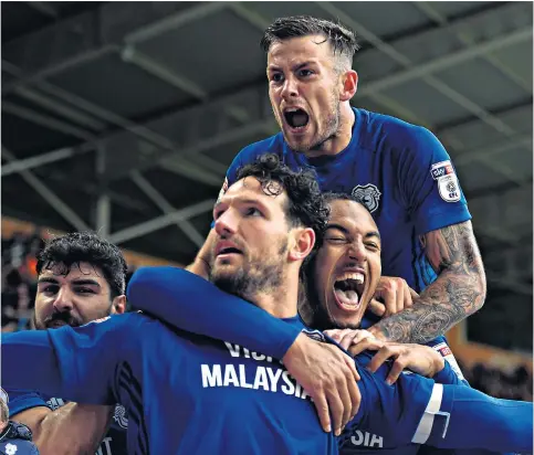  ??  ?? High life: Cardiff players, and Neil Warnock (left), in celebratio­n mood