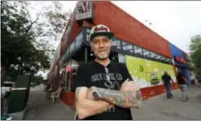  ?? AP PHOTO/DAVID ZALUBOWSKI ?? In this Sunday photo, Jim Norris poses for a photo outside of his informatio­n cafe called Mutiny in south Denver. Norris is hoping to license his storefront as one of the nation’s first legal marijuana clubs.