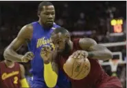  ?? TONY DEJAK — THE ASSOCIATED PRESS FILE ?? In this Dec. 25, 2016photo, the Cleveland Cavaliers’ LeBron James drives against Golden State Warriors’ Kevin Durant during an NBA basketball game in Cleveland.