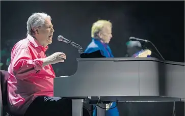  ?? Gina Ferazzi Los Angeles Times ?? BRIAN WILSON adds his vocals to a tune during his Pet Sounds Live tour stop at the Pantages Theatre on Friday night. The concert featured the full 1966 album along with a lively assortment of Beach Boys songs.