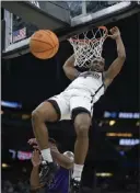  ?? PHELAN M. EBENHACK – THE ASSOCIATED PRESS ?? San Diego State's Lamont Butler, who scored 12 points, dunks over Alex Williams of Furman during Saturday's game.