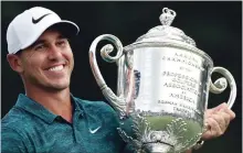  ?? ASSOCIATED PRESS FILE PHOTO ?? Golfer Brooks Koepka holds the Wanamaker Trophy after he won the PGA Championsh­ip at Bellerive Country Club in St. Louis in August.