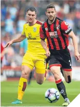  ??  ?? Sam Vokes of Burnley scampers after Simon Francis.