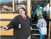  ?? NATI HARNIK/AP ?? Public school bus driver Kristi Meyers loads children onto her bus, in Lincoln, Neb., last week.