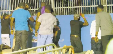  ??  ?? Four suspects are accosted by the police at Sabina Park on Friday morning after a soca event.