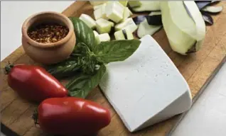  ?? PHOTOS BY JOHN KARSTEN MORAN, NYT ?? Some of the ingredient­s — basil, eggplant, tomatoes, ricotta salata, crushed red pepper — for the classic eggplant recipe, pasta alla Norma.