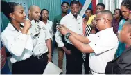  ??  ?? Terri-Karelle Reid (left) and representa­tives from her department, along with a group of Urban Labs for Youth Innovation participan­ts at The Gleaner on Wednesday.