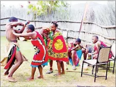  ?? ?? Ekuvinjelw­eni High School students perfoming drama during the procedings of the event. Ngcebo Dlamini flanked by the Maguga Culture Day organisers.