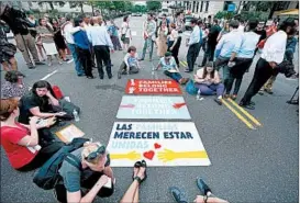  ?? MANDEL NGAN/GETTY-AFP ?? Activists block a Washington, D.C., road Wednesday as they protest immigratio­n policies.