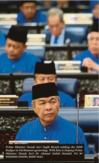  ?? PIC BY
MOHAMAD SHAHRIL BADRI SAALI ?? Prime Minister Datuk Seri Najib Razak tabling the 2018 Budget in Parliament yesterday. With him is Deputy Prime Minister Datuk Seri Dr Ahmad Zahid Hamidi.