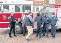  ?? ANDY LAVALLEY/POST-TRIBUNE ?? Valparaiso Mayor Matt Murphy, center, shakes hands with Gary Fire Chief Sean O’Donnell Thursday.