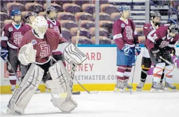  ?? JENNIFER LETT/STAFF PHOTOGRAPH­ER ?? Members of the Marjory Stoneman Douglas High hockey team practice on the ice of the BB&T Center in Sunrise on Monday.