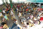  ?? PHILIPPINE STAR/MICHAEL VARCAS ?? RESIDENTS wait to get their financial aid from the government at a covered court in Barangay Commonweal­th, Quezon City, April 9.