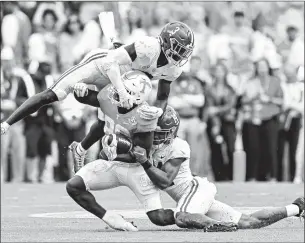  ?? Wade Payne Associated Press ?? TENNESSEE TIGHT END Princeton Fant is tackled by Alabama defensive backs Terrion Arnold, left, and Brian Branch. Tennessee had not beaten a top-10 team since 2006.