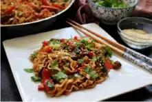  ?? Gretchen McKay/Post-Gazette ?? Fast and easy, this stir-fry featuring sliced lamb and Chinese egg noodles in a spicy sauce is perfect for Ramadan.
