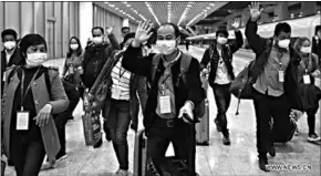  ??  ?? Migrant workers arrive at Guangzhou South Railway Station in Guangzhou, south China’s Guangdong Province, March 19, 2020. With a high-speed railway train carrying 551 migrant workers departing central China’s Hubei Province Thursday, the province hard-hit by the coronaviru­s are sending more workers to south China’s manufactur­ing heartland Guangdong Province. (Photo: Xinhua)