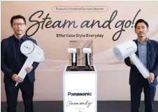  ?? ?? Keisuke (left) and Panasonic Malaysia general manager (appliances marketing) Shinichi Tsuda hold the cut-out versions of the new handheld garment steamers, of which the actual-sized devices are also shown in the photo.