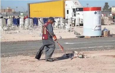  ?? COURTESY PHOTO ?? Cleanup crews pick up trash and put away chairs Thursday at the site of the papal Mass in Juárez.