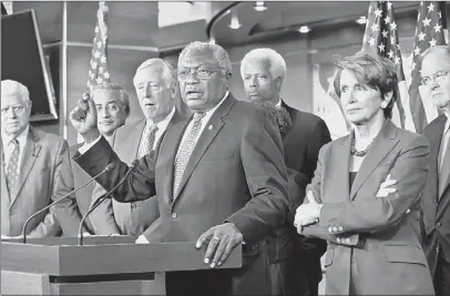  ?? J. Scott Applewhite/associated Press ?? Assistant Minority Leader James Clyburn of D-S.C., center, accompanie­d by House Minority Leader Nancy Pelosi, D-Calif., second from right, and others, gestures during a news conference Tuesday in Washington, to discuss the Pennsylvan­ia voter ID law...