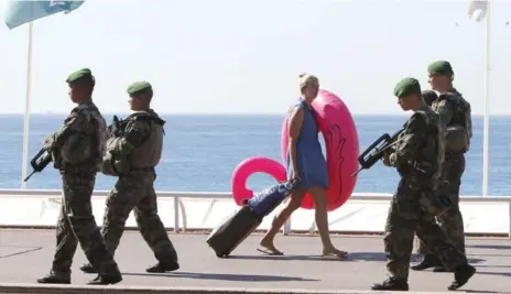  ?? CLAUDE PARIS/THE ASSOCIATED PRESS ?? Soldiers patrol the Promenade des Anglais in Nice. Since January 2015, Daesh-inspired attackers have killed at least 235 people in France.