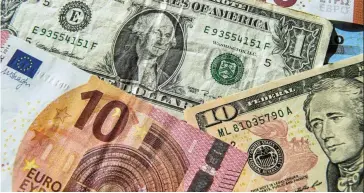  ?? — AFP ?? Gaining strength: A file picture showing the euro and US dollar bills. The euro is trading around US$1.04 (RM4.73) – more than 8% above its nadir from late September.