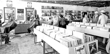  ??  ?? Seasick Records is home to about 8,000 vinyl LPs, as well as Newman’s Classic Cuts barbershop.