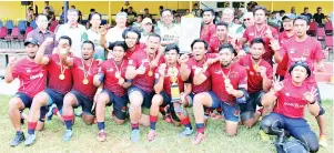  ??  ?? Karim (sixth right) presents the challenge trophy to RIMO 7s captain Azwan while (from fourth left) Morshidi, Richard Song, Shahrul and other guests look on at Song Kheng Hai Rugby Field yesterday.