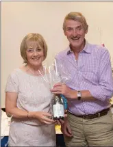  ??  ?? JohnWaters, a winner in the Lady President’s Prize in Blainroe Golf Club, receives his prize from the Lady President Bernie Nelson.