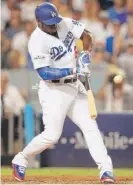  ?? | GETTY IMAGES ?? Dodgers outfielder Yasiel Puig hits a single in the fourth inning Saturday against the Diamondbac­ks.