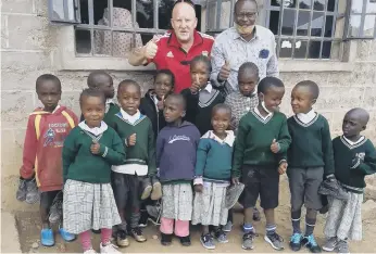  ?? ?? Gary with schoolchil­dren in Keroche.