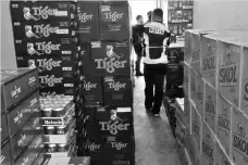  ??  ?? The 838 boxes of alcoholic drinks that were seized by marine police at a Mile 5 shop.