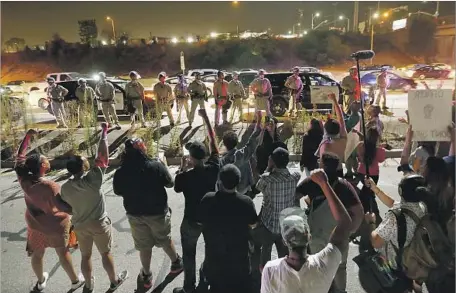  ?? Photograph­s by Luis Sinco Los Angeles Times ?? PROTESTERS CONFRONT California Highway Patrol officers Sunday in Inglewood. Demonstrat­ors briefly blocked traffic on the 405.