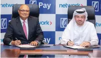  ?? ?? Nandan Mer, group CEO Network Internatio­nal; and Ahmed Al Qassim, senior executive vice-president and group head, corporate and institutio­nal banking at Emirates NBD, signing the agreement in Dubai. — supplied photo